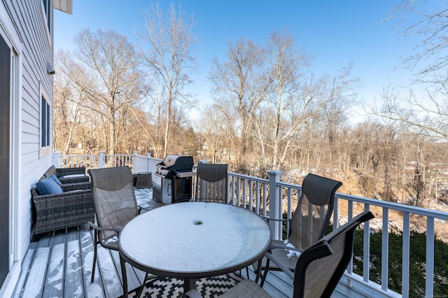 wooden deck featuring outdoor dining area and grilling area