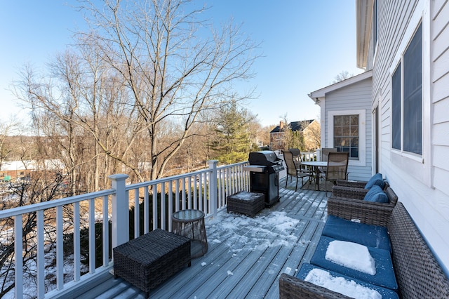 wooden deck featuring outdoor dining space and a grill