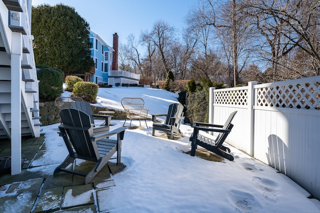 snow covered patio with fence