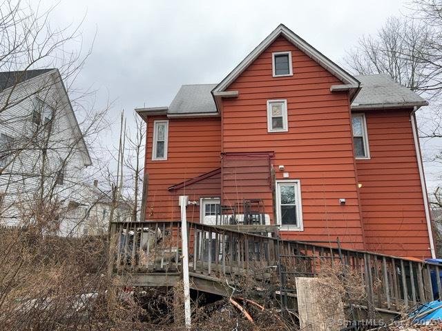 back of property with a wooden deck