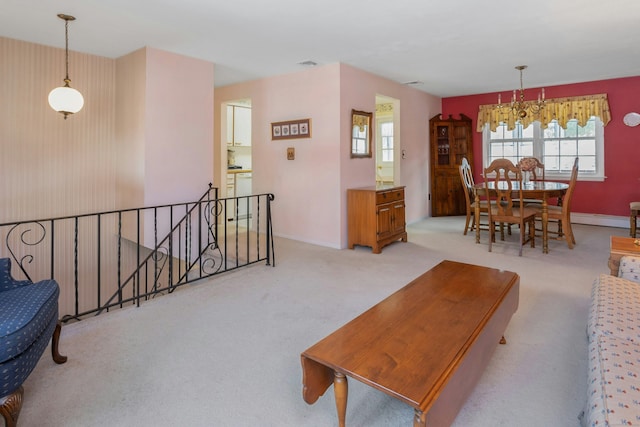 carpeted living area featuring visible vents, a baseboard heating unit, and baseboards