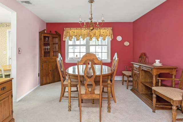 dining room featuring baseboards, visible vents, baseboard heating, and light carpet