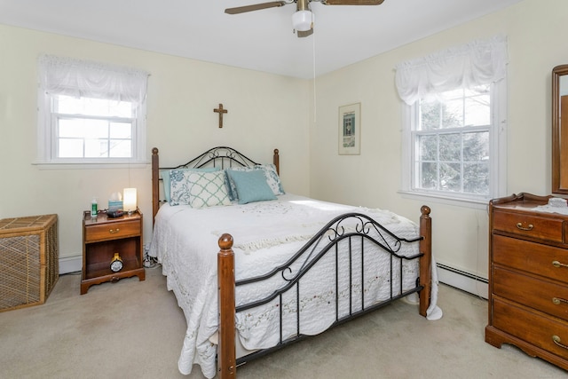 bedroom featuring a baseboard heating unit, light carpet, baseboard heating, and ceiling fan