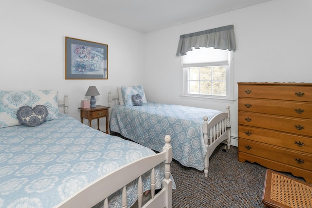 carpeted bedroom featuring a baseboard heating unit