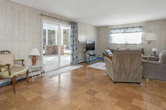 living room featuring tile patterned floors, baseboard heating, and a baseboard radiator