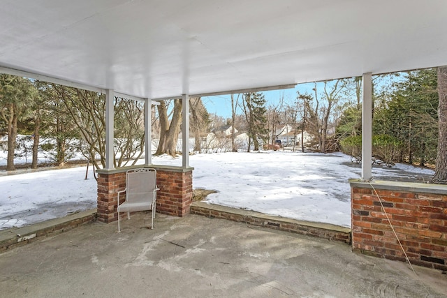 yard covered in snow featuring a patio