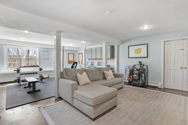 living area featuring a baseboard heating unit, concrete flooring, and recessed lighting