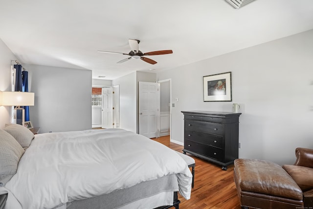 bedroom with visible vents, wood finished floors, and a ceiling fan