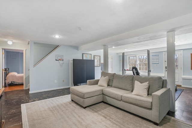 living area featuring recessed lighting, finished concrete flooring, and baseboards