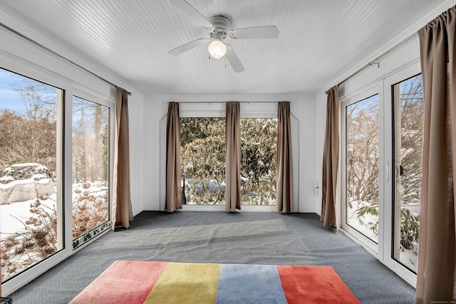 unfurnished sunroom with ceiling fan