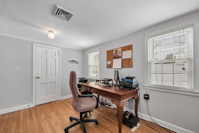 office space with light wood-type flooring