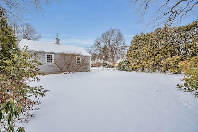 view of yard layered in snow