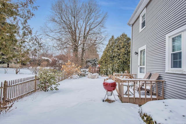 snowy yard featuring a deck