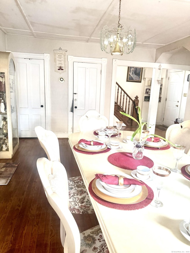 dining space featuring wood-type flooring and a chandelier