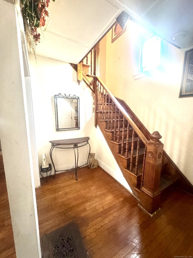 stairs featuring hardwood / wood-style floors