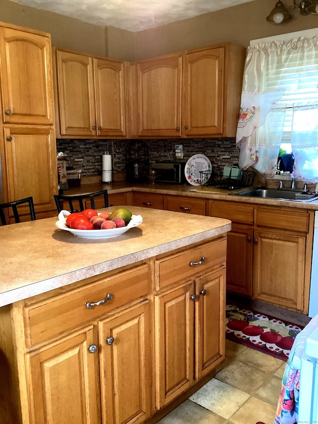 kitchen featuring decorative backsplash and light countertops