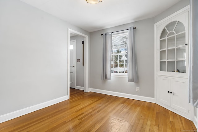 spare room featuring wood-type flooring