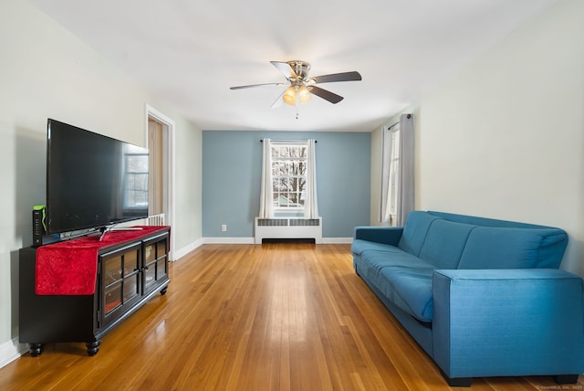 living room featuring ceiling fan, radiator heating unit, and hardwood / wood-style floors