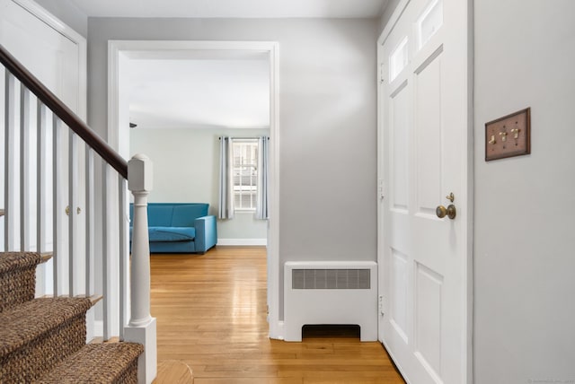 entryway with hardwood / wood-style flooring and radiator heating unit