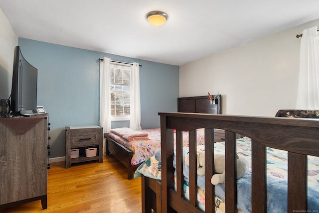 bedroom with light wood-type flooring