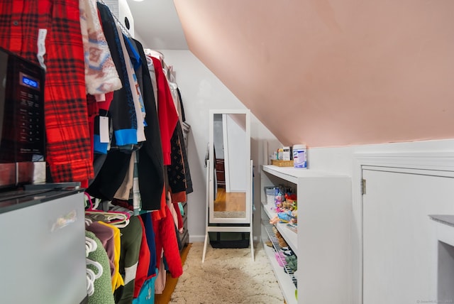 walk in closet featuring vaulted ceiling