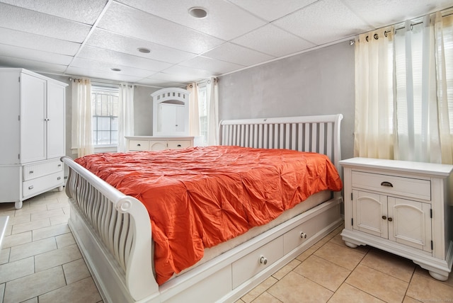 tiled bedroom with a drop ceiling