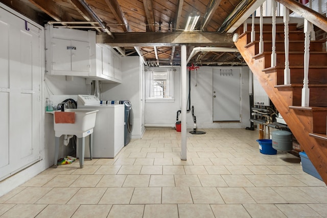 basement with sink and washer and dryer