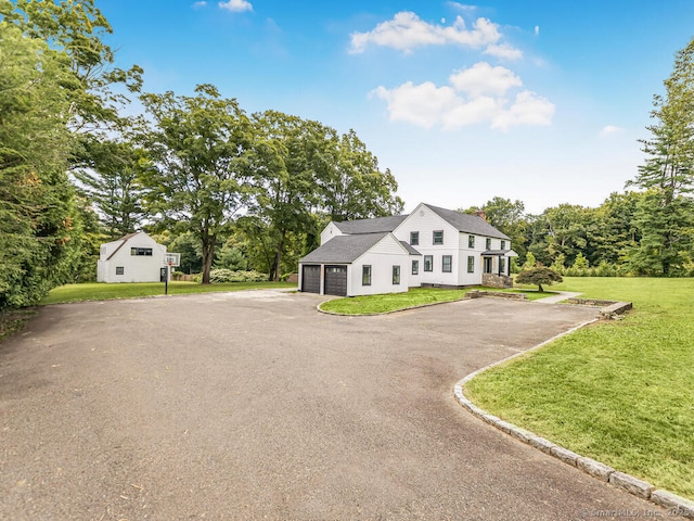 view of front facade with a garage and a front lawn