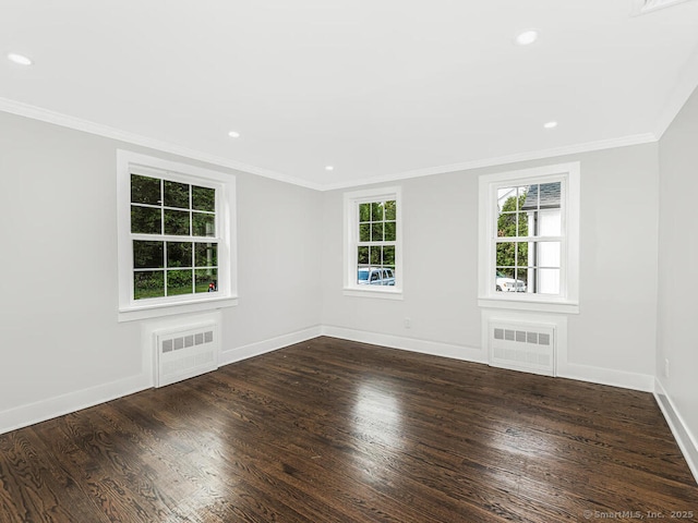 empty room featuring radiator, crown molding, and dark hardwood / wood-style floors