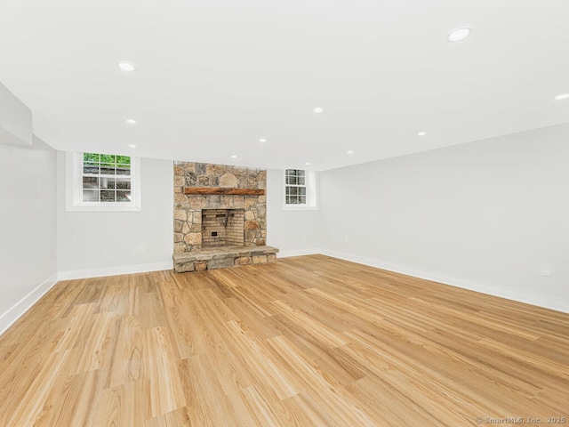 unfurnished living room with a fireplace and light hardwood / wood-style flooring