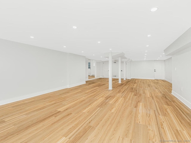 basement with light hardwood / wood-style floors