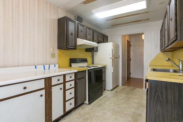 kitchen featuring dark brown cabinetry, electric range oven, sink, and white fridge