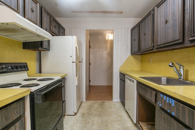 kitchen featuring white appliances, dark brown cabinetry, and sink