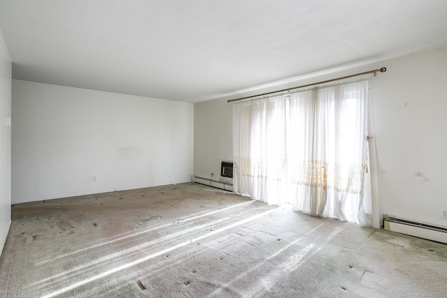 empty room with a baseboard radiator and light colored carpet