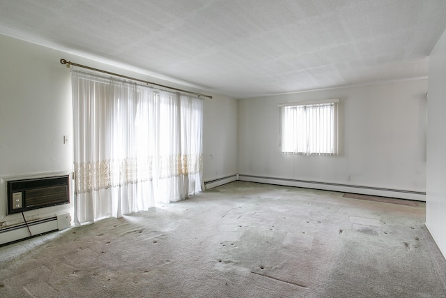 carpeted empty room featuring baseboard heating and a wall unit AC