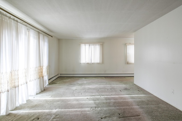 unfurnished room featuring a baseboard heating unit