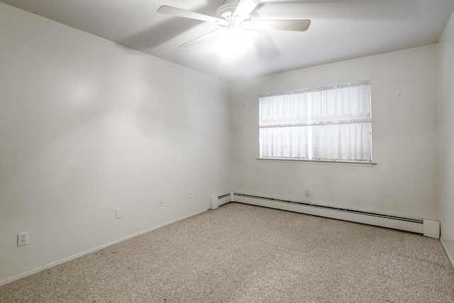 carpeted spare room with a baseboard heating unit and ceiling fan