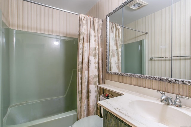 full bathroom with vanity, shower / bath combination with curtain, and toilet