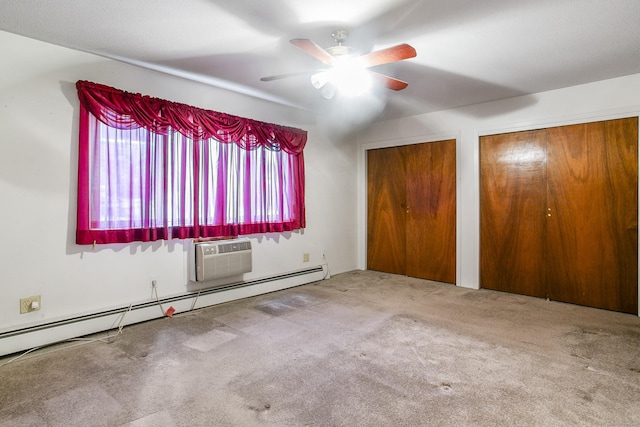 unfurnished bedroom with multiple closets, carpet flooring, a wall mounted AC, and a baseboard heating unit