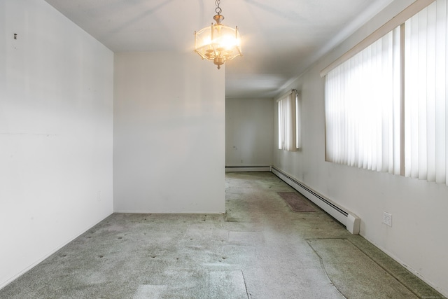 empty room with a baseboard radiator, light carpet, and an inviting chandelier