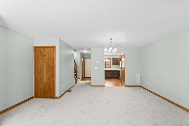 unfurnished living room featuring light colored carpet and a notable chandelier