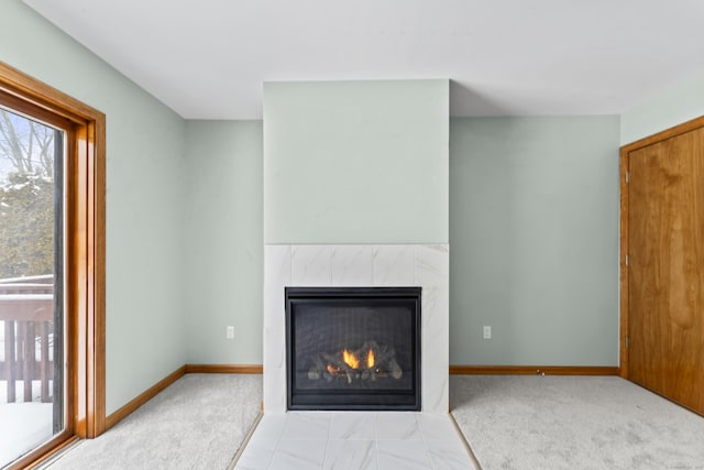 interior details featuring carpet floors and a tile fireplace