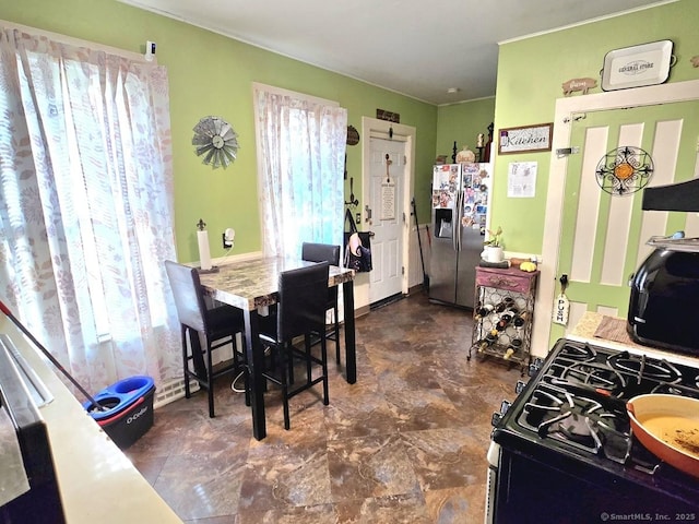 kitchen with stainless steel fridge and gas stove