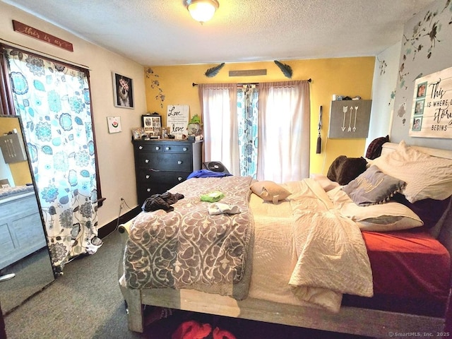 bedroom with carpet floors and a textured ceiling