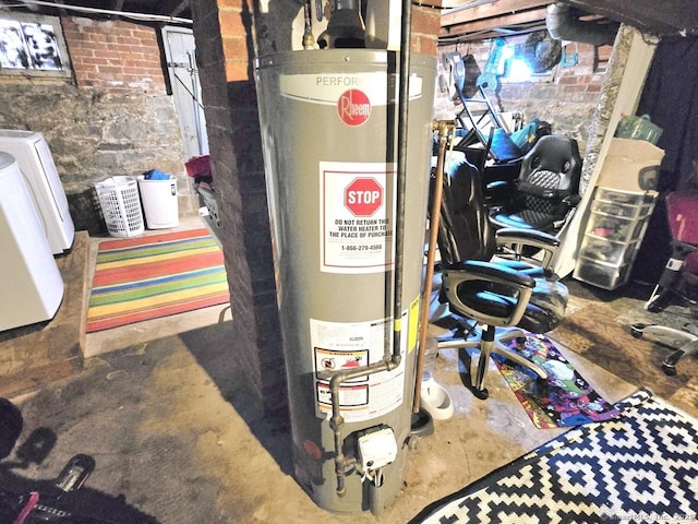 utilities featuring gas water heater and washer / dryer