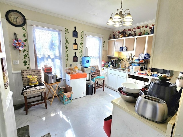 interior space featuring ornamental molding, sink, pendant lighting, and a chandelier