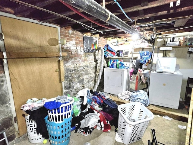 basement featuring brick wall and independent washer and dryer