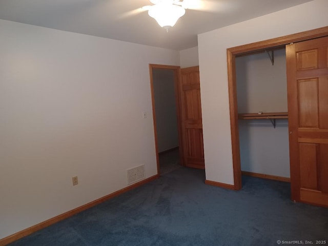 unfurnished bedroom with a closet, ceiling fan, and dark colored carpet