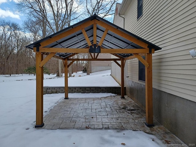 snow covered patio with a gazebo