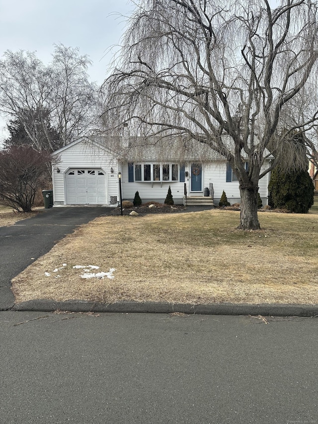 view of front of home with a garage and a front yard